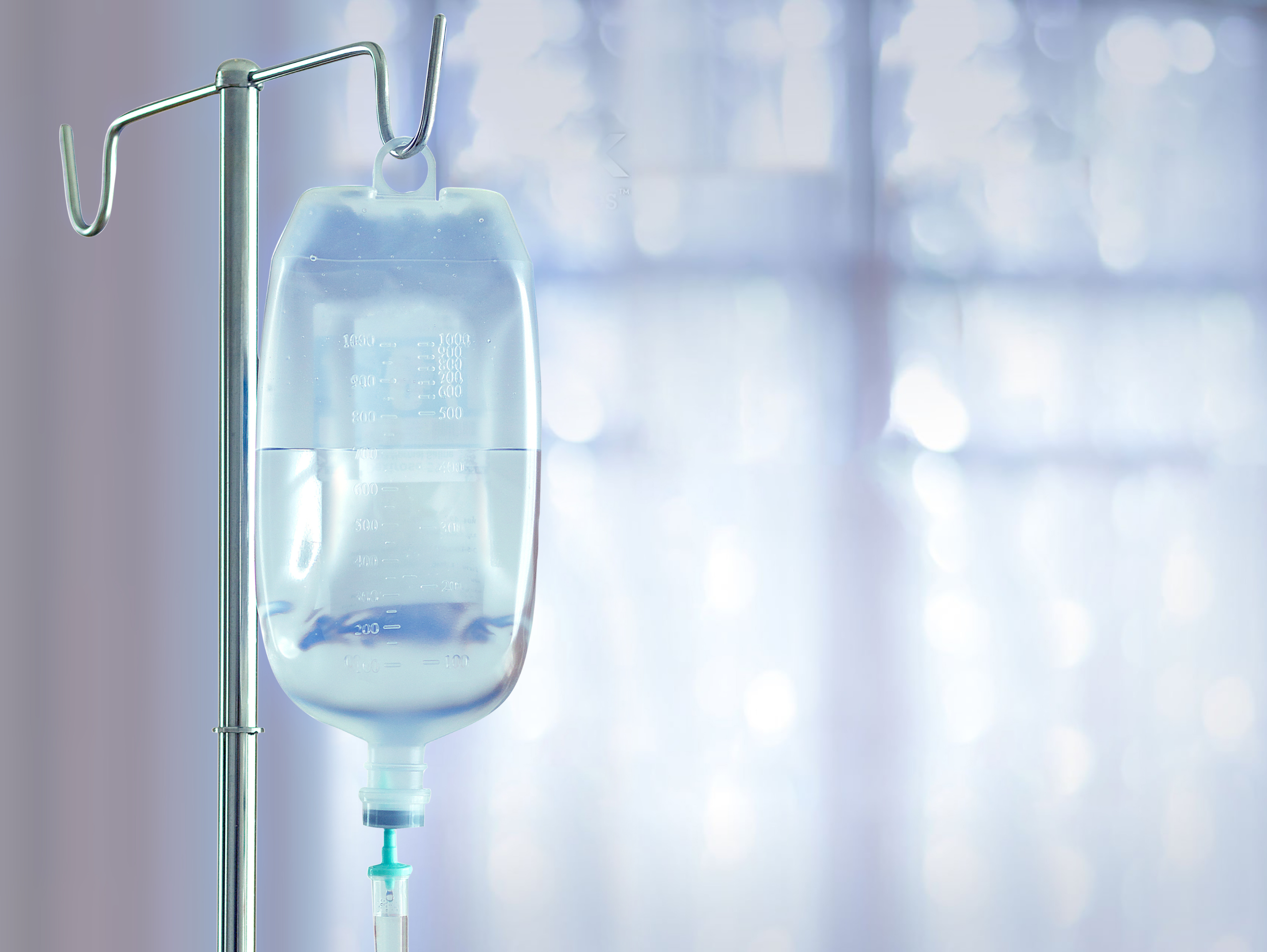 and iv bag full of liquid hanging on a stand